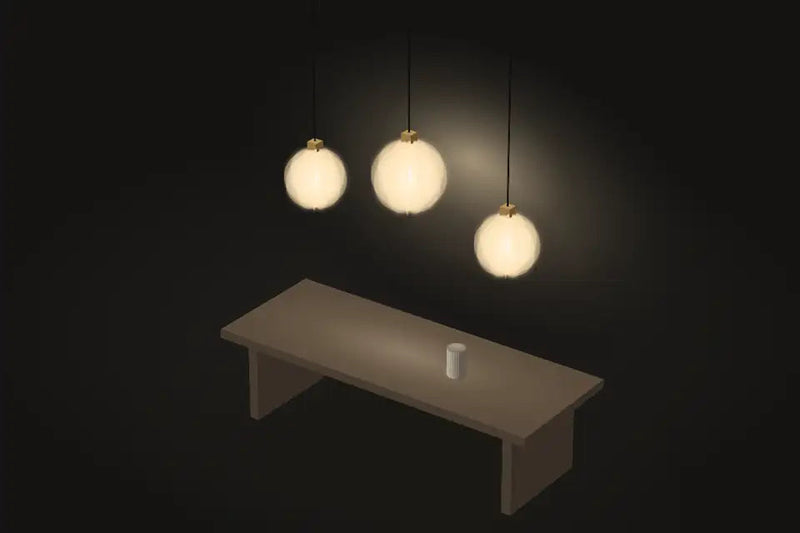 Three glass globe pendants above a dining table