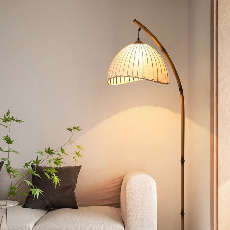 Moodly Arc floor lamp beside a sofa