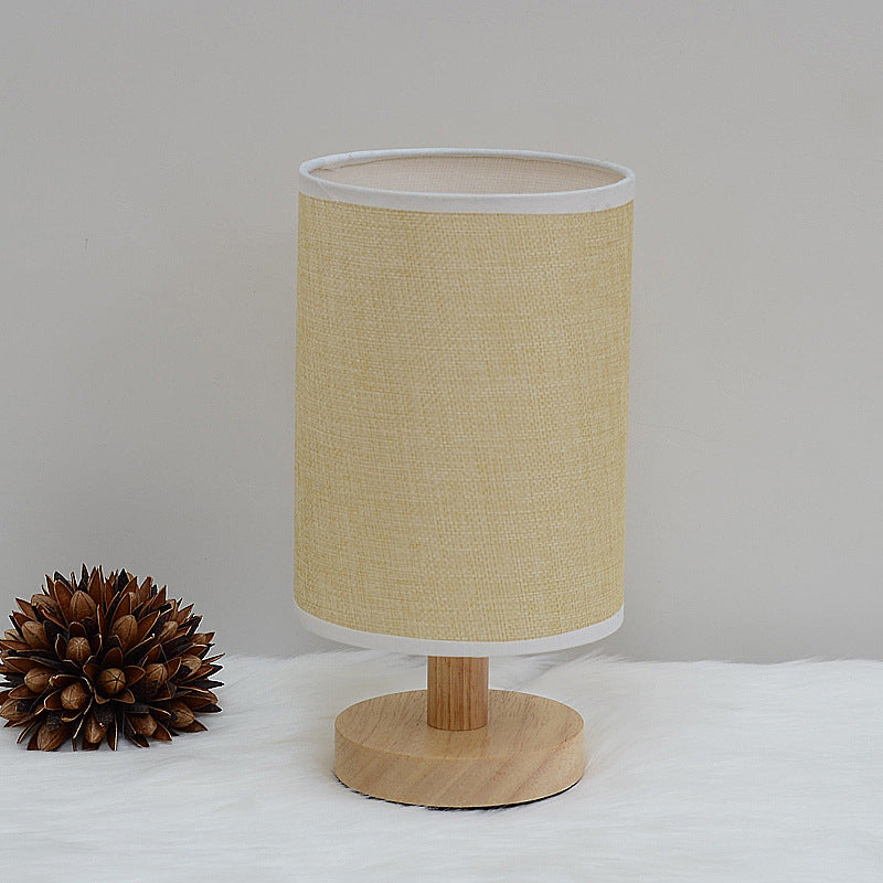 Moodly Nook table lamp with a jute shade and a round wooden base, switched off