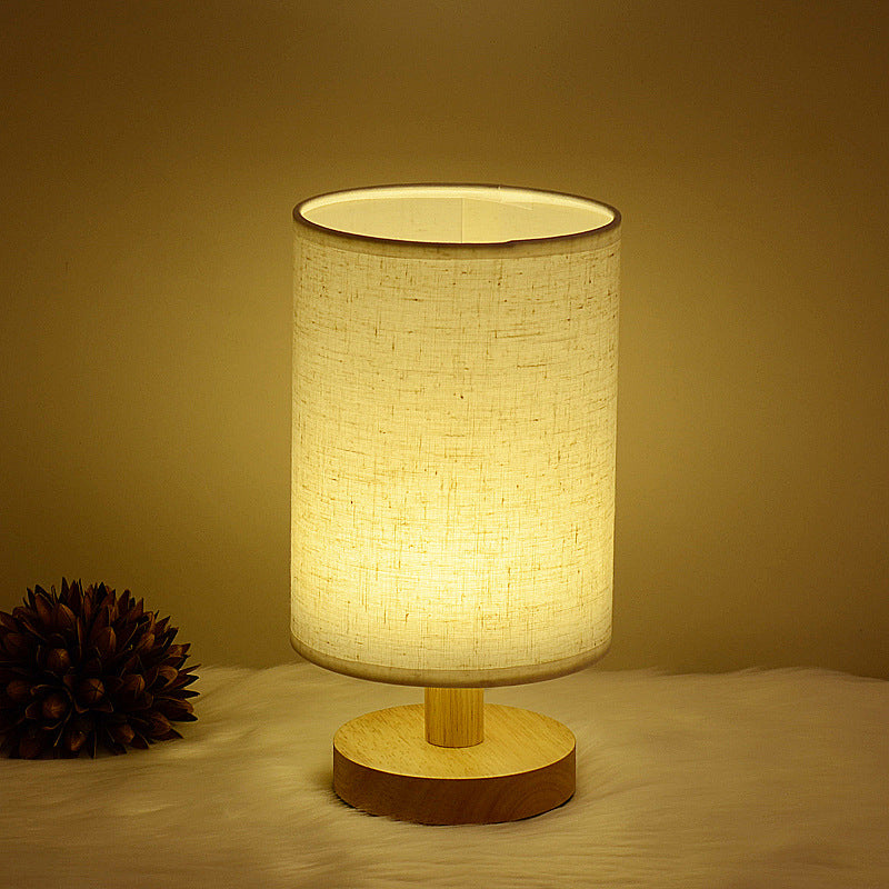 Moodly Nook table lamp with a linen shade glowing in a dark room