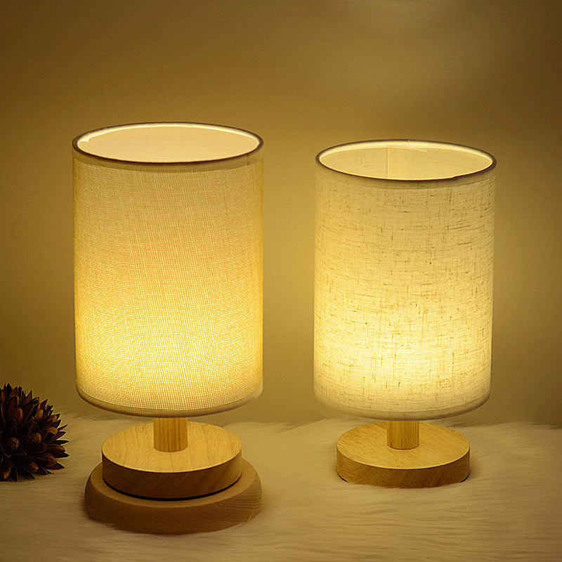 Two Moodly Nook table lamps with fabric shades glowing warm on wooden bases