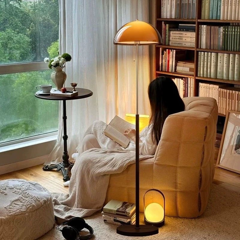 Moodly Amber floor lamp with an amber dome shade glowing in a reading corner