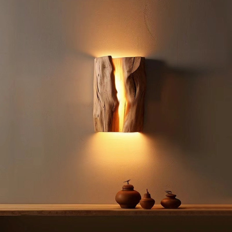 Moodly Grain solid wood LED wall lamp glowing warm on a wall