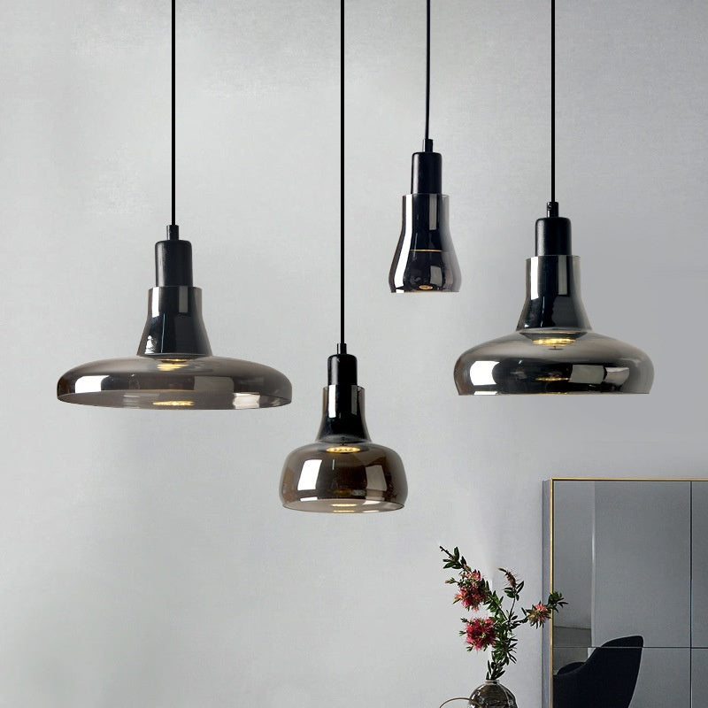 Four Moodly Smoke smoked glass pendant lights in different shapes hanging together