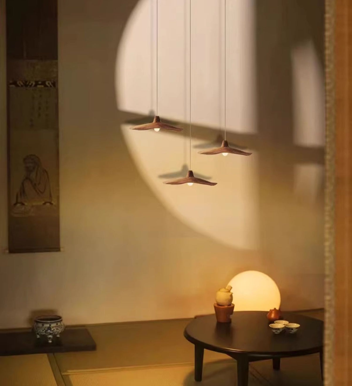 Three Moodly Dune pendant lights glowing warm above a low table