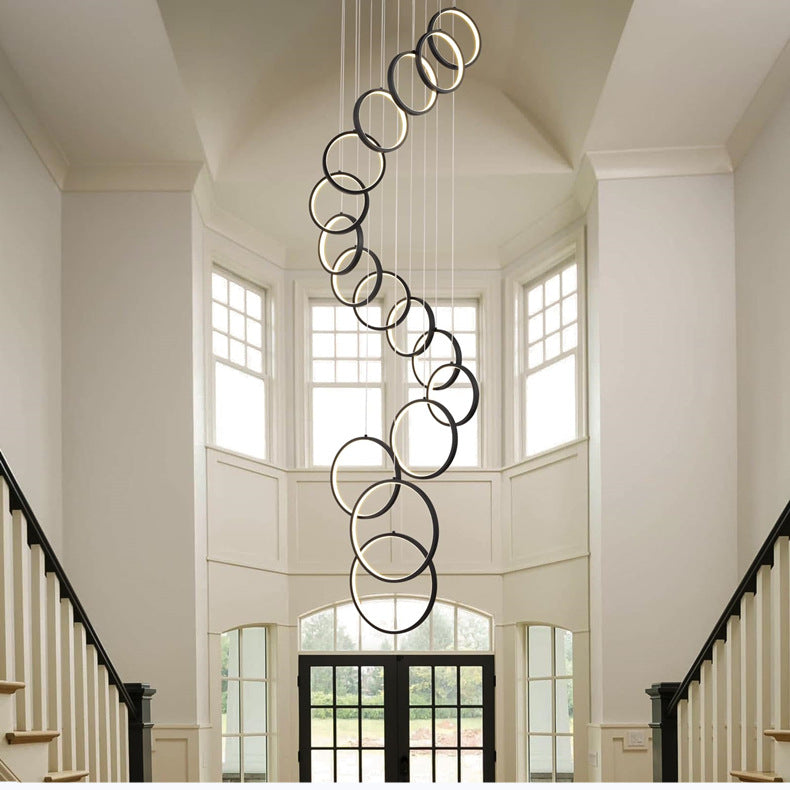 Moodly Orbit LED ring chandelier hanging in a bright stairwell