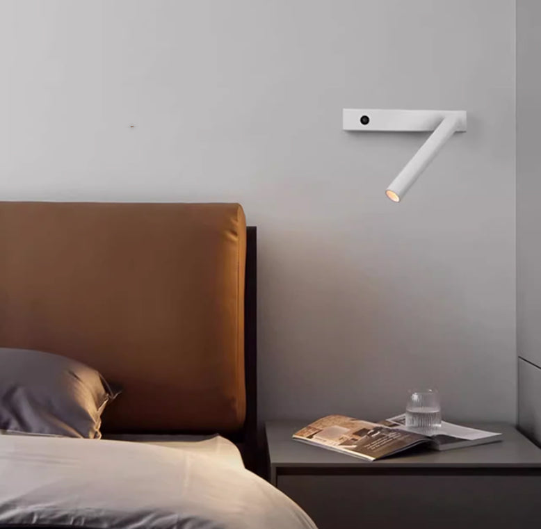 White Moodly Beam wall reading light beside a bed