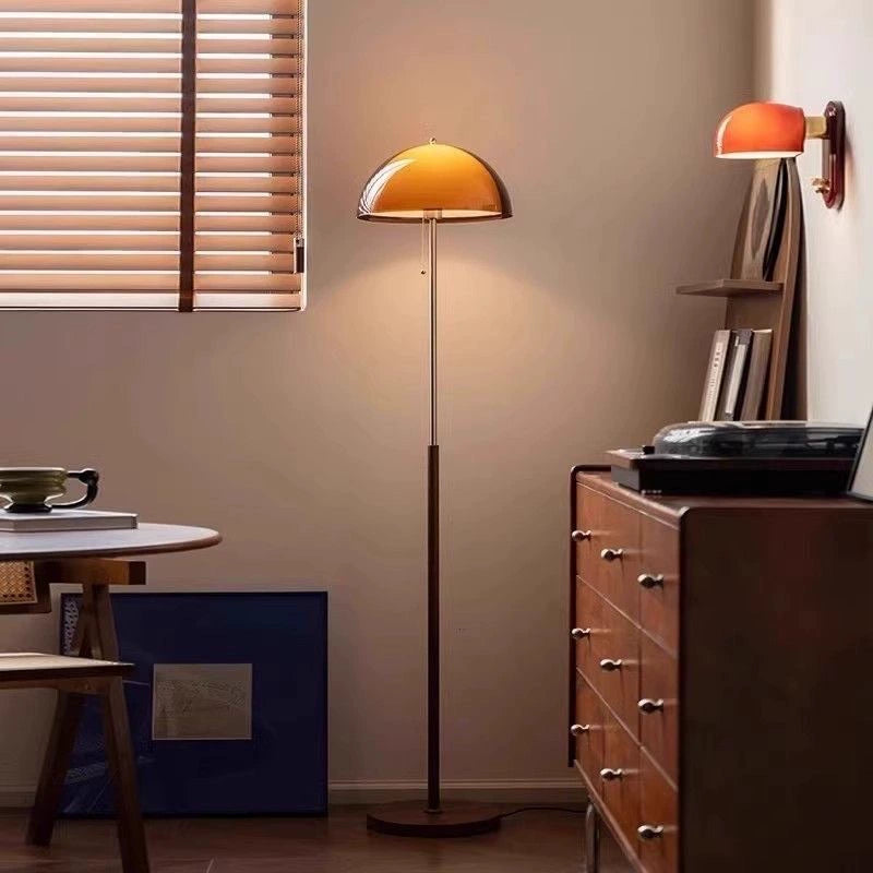 Moodly Amber floor lamp beside a wooden sideboard